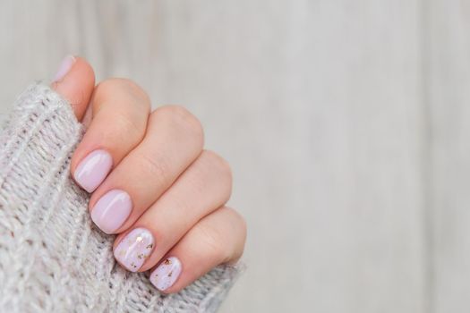 Closeup elegant pastel natural modern design manicure. Female hands. Gel nails. Nude manicure. Beige color. Clean skin. Spa salon, advertisement. Skin care. Beauty. Nail care. Beauty treatment. Copy space