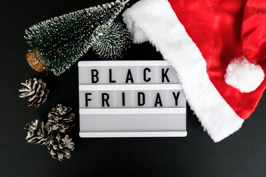 Lightbox with text BLACK FRIDAY around christmas new year decoration. Santas hat. Sale shopping concept. Template Black friday sale mockup fall promotion advertising. Holiday Big sale. Cyber monday.