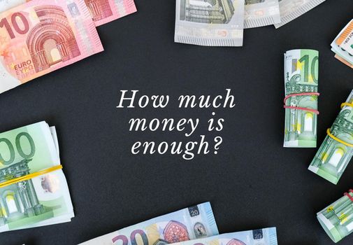 HOW MUCH MONEY IS ENOUGH Quote Euro bills are creative layout. Business concept, development perspective. Flat lay. Top view. Minimal creative style pattern. Business budget of wealth and prosperity finance.