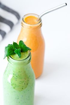 Seasonal Matcha green vegan smoothie with chia seeds and mint pumpkin carrot smoothie drink detox Breakfast. Clean eating, weight loss, healthy dieting food concept Fruit vegetable drink fitness