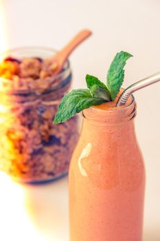 Seasonal pumpkin carrot smoothie drink detox with eco metal drinking straw Glass jar granola muesli oatmeal breakfast. Orange smoothie. Clean eating, weight loss, healthy dieting food concept Fruit vegetable drink fitness