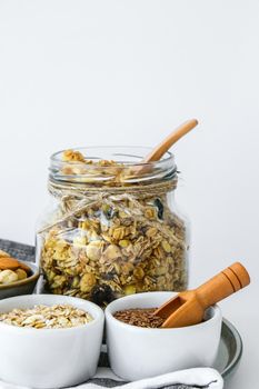 Healthy breakfast. Oatmeal Granola with greek yogurt and nuts banana muesli in jars on light background. Vegan, vegetarian and weight loss diet concept. Detox menu. Healthy eating food