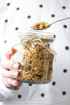 Female hands, woman eating Healthy breakfast. Oatmeal Granola muesli in jar. Vegan, vegetarian and weight loss diet concept. Detox menu. Healthy eating food