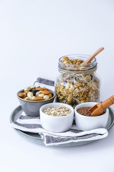 Healthy breakfast. Oatmeal Granola with greek yogurt and nuts banana muesli in jars on light background. Vegan, vegetarian and weight loss diet concept. Detox menu. Healthy eating food