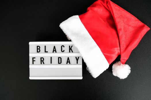 Lightbox with text BLACK FRIDAY around christmas new year decoration. Santas hat. Sale shopping concept. Template Black friday sale mockup fall promotion advertising. Holiday Big sale. Cyber monday.