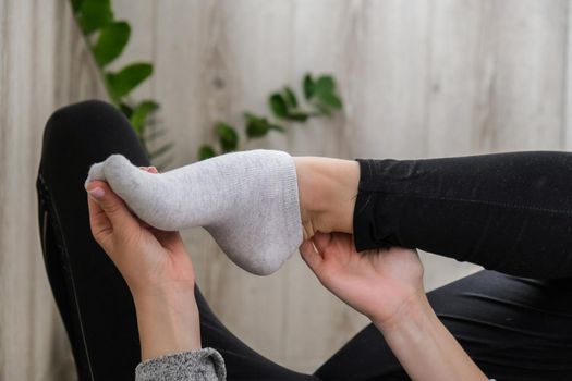 Young millennial blonde woman doing yoga exercise stretching fitness at balcony home. Mindfulness meditation. Relax breathe easy pose gym healthy lifestyle concept. Self-isolation is beneficial