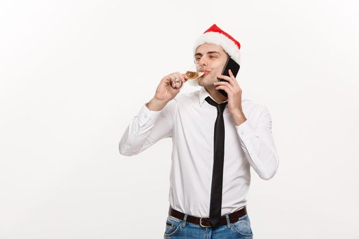 Christmas Concept - Handsome Business man talking on phone and holding glass of champange celebrating Chirstmas and New year.
