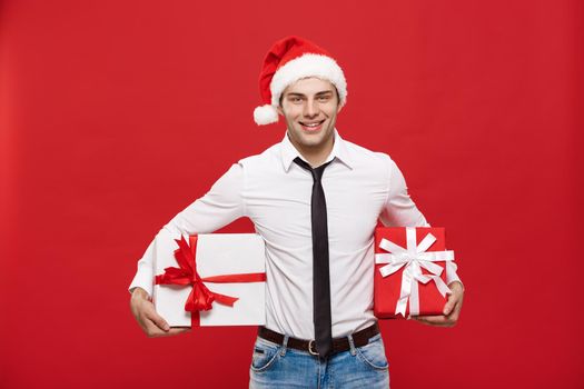 Christmas Concept - portrait happy Santa christmas businessman exciting with his gift over red background.