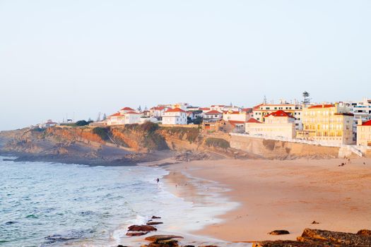 Praia das Macas Apple Beach in Colares, Portugal, on a stormy day before sunset Small city on ocean shore