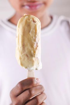 close up of vanila flavor ice cream in a container .