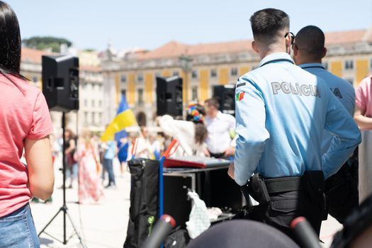 Portugal, Lisbon April 2022: The demonstration on Commerce Square in support of Ukraine and against the Russian aggression. Protesters against Russia's war Many people with Ukrainian flags. Crowd