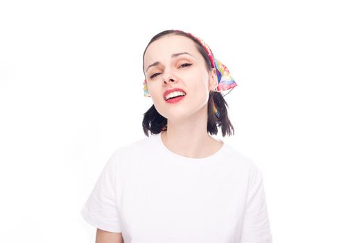 woman in a white t-shirt, in a bandana on her head, white studio background. High quality photo