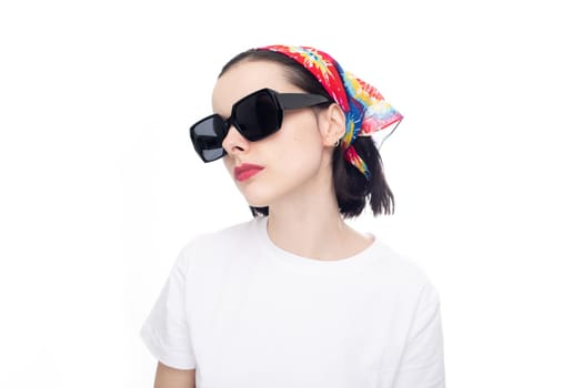 woman in a summer scarf with sunglasses and a white T-shirt. High quality photo