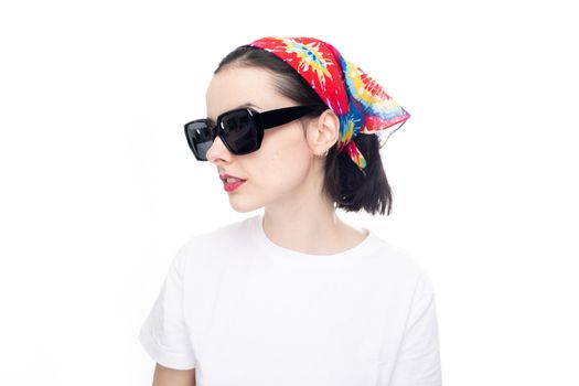 woman in a summer bandana with sunglasses and a white T-shirt. High quality photo