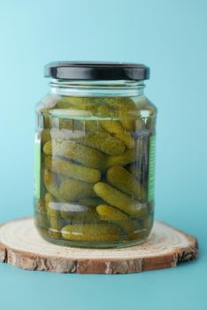 bottle of pickled cucumbers, pickles on table .