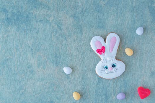 Easter bunny with chocolate eggs and red heart on a wooden green background with space for text. copy space, top view, flat lay, creative, Happy Easter,