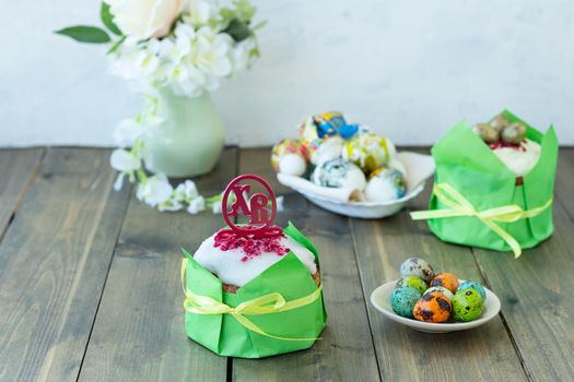 Easter wooden table with Easter cakes and colored eggs. topper with Russian letters XB means Christ is Risen. Happy easter concept. soft focus