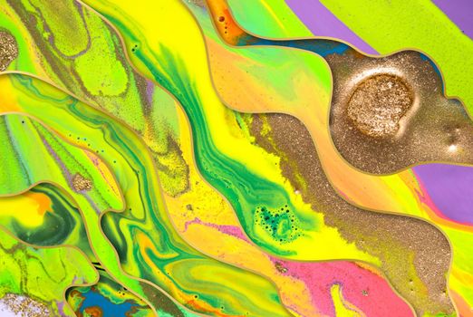 Gold dust and waves on fluorescent inks background