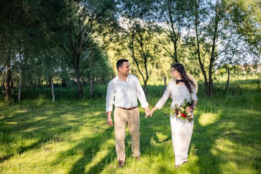 nice portrait of beautiful and young groom and bride outdoors