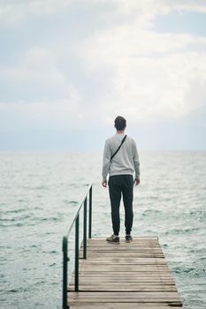 A young man admires Lake Ohrid. View from the back. High quality photo