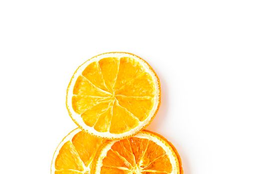 flat lay with ripe and dried round slices of orange isolated on white background. fruit chips. healthy sweets. soft focus