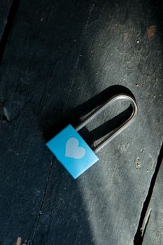 Valentine card. Blue padlock with white heart on a vintage background.