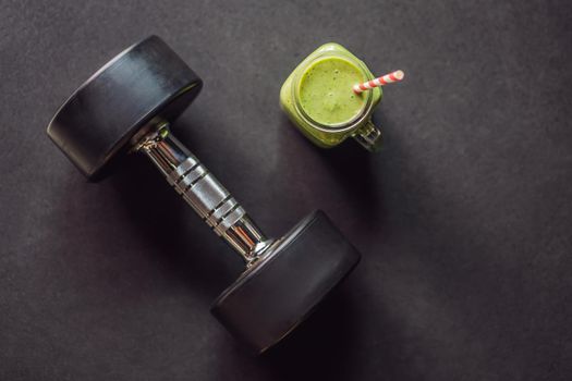 Green smoothies and dumbbells in the gym.