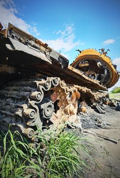 Kyiv region, Ukraine - May 15, 2022: War in Ukraine. Highway Kyiv - Zhytomyr. People take selfies against destroyed russian tank after russian atack in Febrary