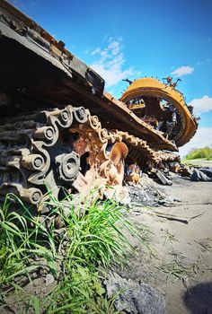 Kyiv region, Ukraine - May 15, 2022: War in Ukraine. Highway Kyiv - Zhytomyr. People take selfies against destroyed russian tank after russian atack in Febrary