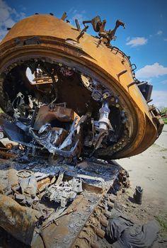 Kyiv region, Ukraine - May 15, 2022: War in Ukraine. Highway Kyiv - Zhytomyr. People take selfies against destroyed russian tank after russian atack in Febrary