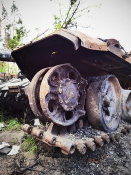 Kyiv region, Ukraine - May 15, 2022: War in Ukraine. Highway Kyiv - Zhytomyr. People take selfies against destroyed russian tank after russian atack in Febrary