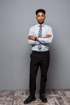 Business Concept - Full length portrait of confident african american businessman in the office
