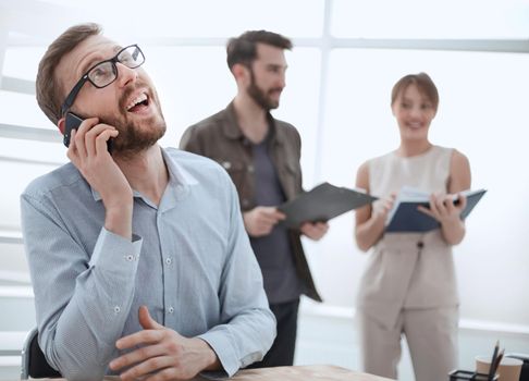 business man talking to a client on a smartphone. people and technology