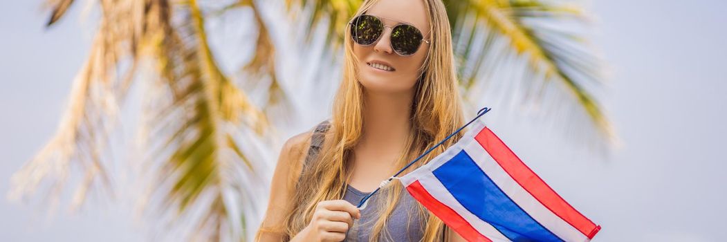 Happy woman having fun at the beach with Thailand flag. Beautiful girl enjoying travel to Asia. BANNER, LONG FORMAT