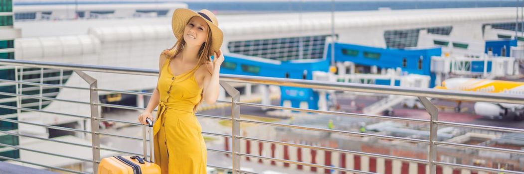 Start of her journey. Beautiful young woman ltraveler in a yellow dress and a yellow suitcase is waiting for her flight. BANNER, LONG FORMAT