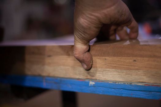 Bonding wooden cubes into one board. Creating a unique wooden product for cutting meat and vegetables. Joinery in the workshop. Sizing details. Woodwork. Do-it-yourself hobbies.