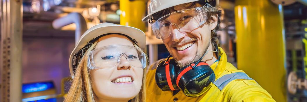 Man and woman in a yellow work uniform, glasses, and helmet in an industrial environment, oil Platform or liquefied gas plant. BANNER, LONG FORMAT