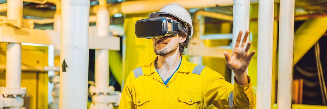 BANNER, LONG FORMAT Young woman in a yellow work uniform, glasses and helmet uses virtual reality glasses in industrial environment,oil Platform or liquefied gas plant.