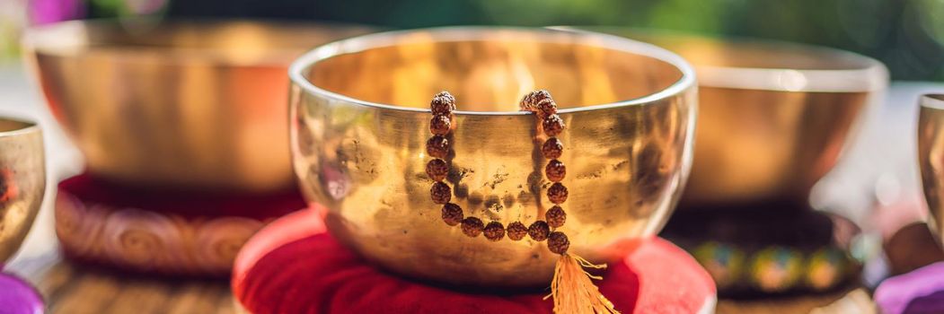 Tibetan singing bowls on a straw mat. BANNER, LONG FORMAT