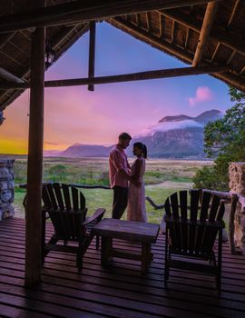 Mountains and grassland near Hermanus at the garden route Western Cape South Africa Whale coast. couple man and woman mid age in front of their lodge during vacation in South Africa