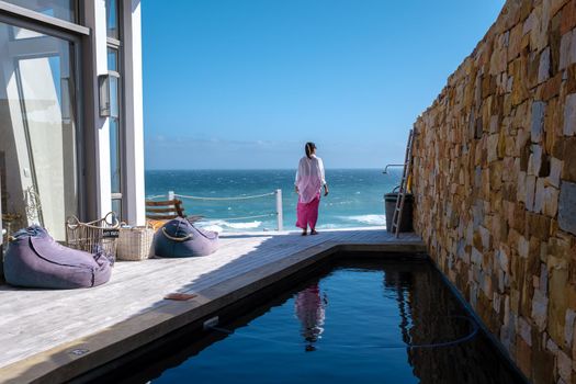 Women watching de ocean on a balcony at De Hoop Nature reserve South Africa Western Cape, white dunes at the de hoop nature reserve which is part of the garden route.