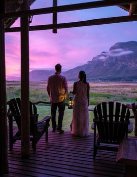 Mountains and grassland near Hermanus at the garden route Western Cape South Africa Whale coast. couple man and woman mid age in front of their lodge during vacation in South Africa