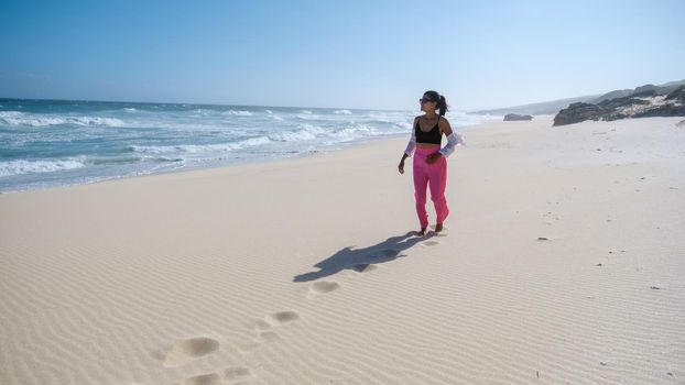 Women walking at the beach De Hoop Nature reserve South Africa Western Cape, the Most beautiful beach of south Africa with the white dunes at the de hoop nature reserve which part of the garden route