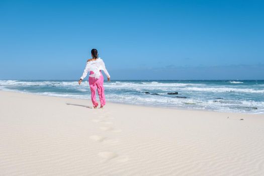 Women walking at the beach De Hoop Nature reserve South Africa Western Cape, the Most beautiful beach of south Africa with the white dunes at the de hoop nature reserve which part of the garden route