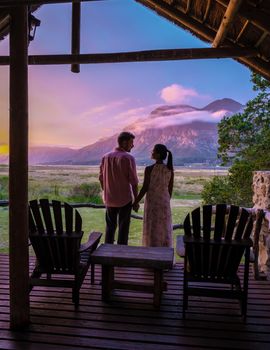 Mountains and grassland near Hermanus at the garden route Western Cape South Africa Whale coast. couple man and woman mid age in front of their lodge during vacation in South Africa