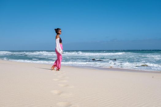 Women walking at the beach De Hoop Nature reserve South Africa Western Cape, the Most beautiful beach of south Africa with the white dunes at the de hoop nature reserve which part of the garden route