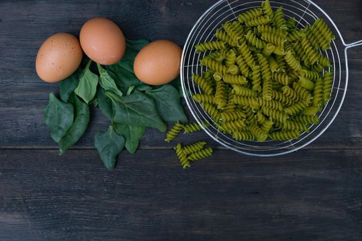 kitchen background with noodles and spinach leaves