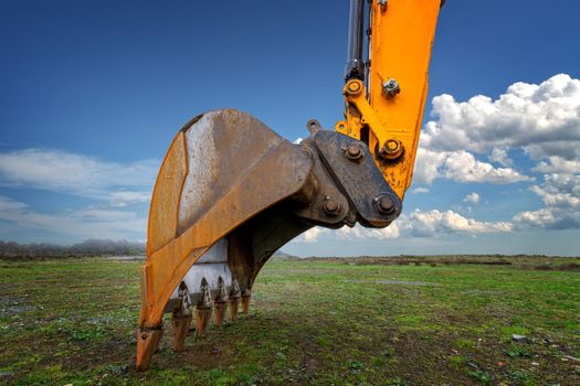 Industrial background. Digger bucket close-up. Construction excavator bucket.