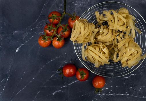 top view cooking ingredients with noodles, tomatoes , eggs and spices