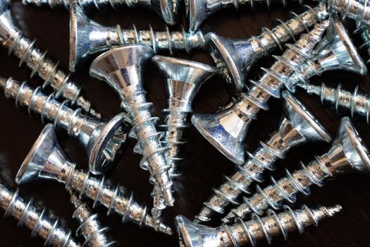 Top view of screws on a black background.